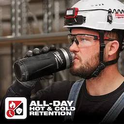 Worker holds an App%20Shot%20Overlay insulated tumbler branded with "PACKOUT" logo, alongside text "ALL-DAY HOT & COLD RETENTION".