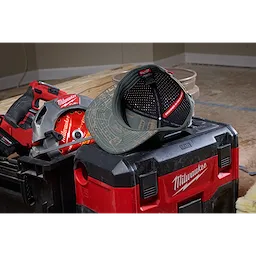 Flat Brim Snapback cap with a printed design, displayed on top of a red and black toolbox next to power tools.