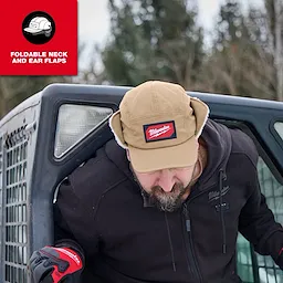 Person wearing a Milwaukee Sherpa-Lined Hat with ear flaps, leaning out of a vehicle in an outdoor setting.