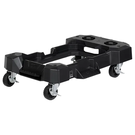 The image shows a Milwaukee Packout Dolly, a black, durable plastic dolly with four caster wheels designed for Milwaukee Packout modular storage system mobility. It features a rectangular frame with cutouts and slots for securing various attachments.