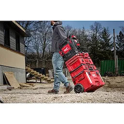 Image of the PACKOUT Rolling Toolbox being used by a worker on a jobsite highlighting the Low-Profile Handle feature