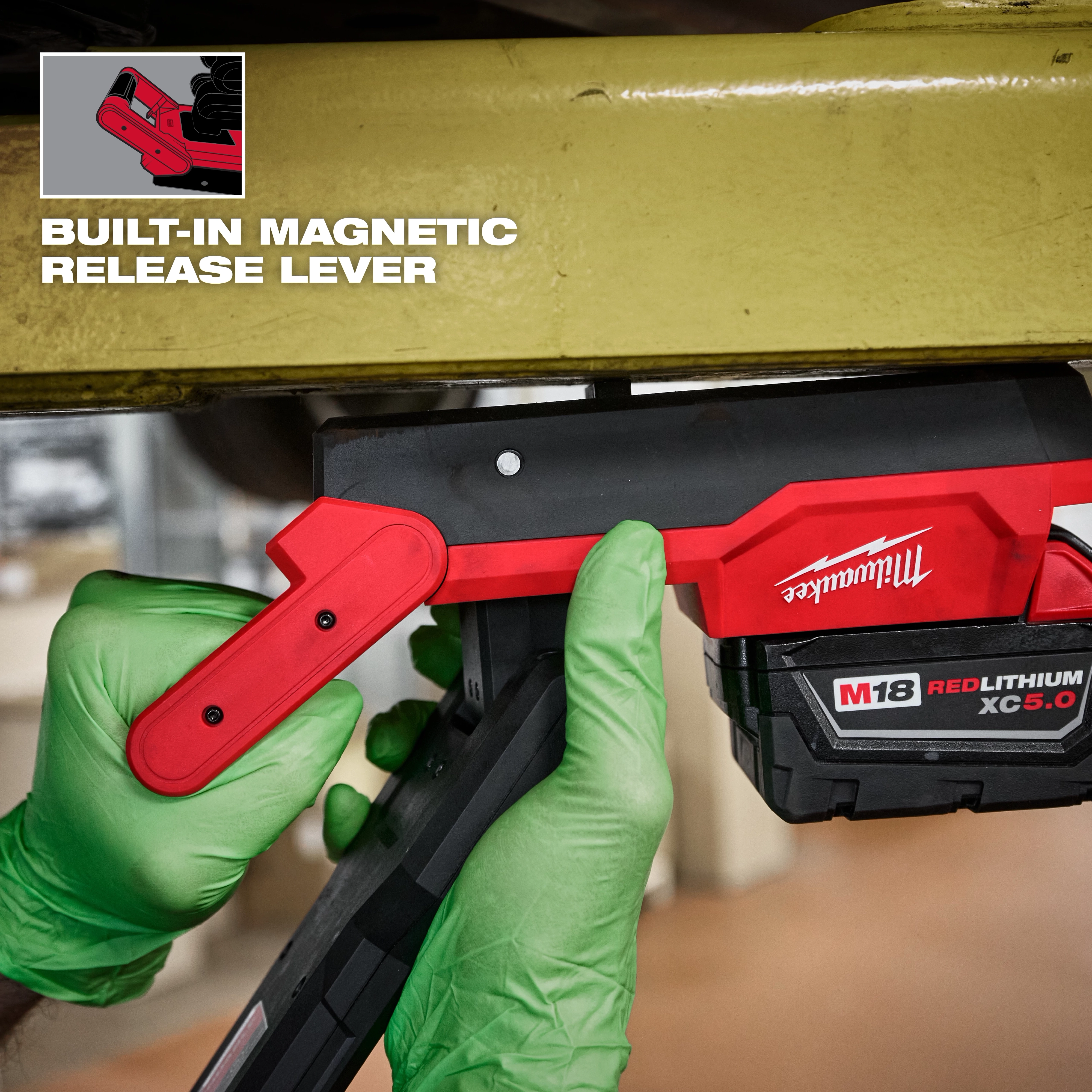 Image of a worker using the Milwaukee M18 Magnetic Extendable Boom Light on a jobsite with the text "Built-In Magnetic Release Lever"