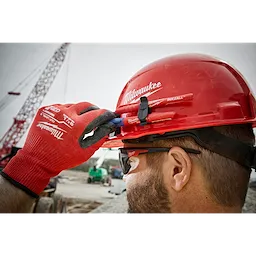 A red hard hat with a front brim and vented design, featuring a 4-point ratcheting suspension system. This is a Red Front Brim Vented Hard Hat w/4pt Ratcheting Suspension - Type 1, Class C.