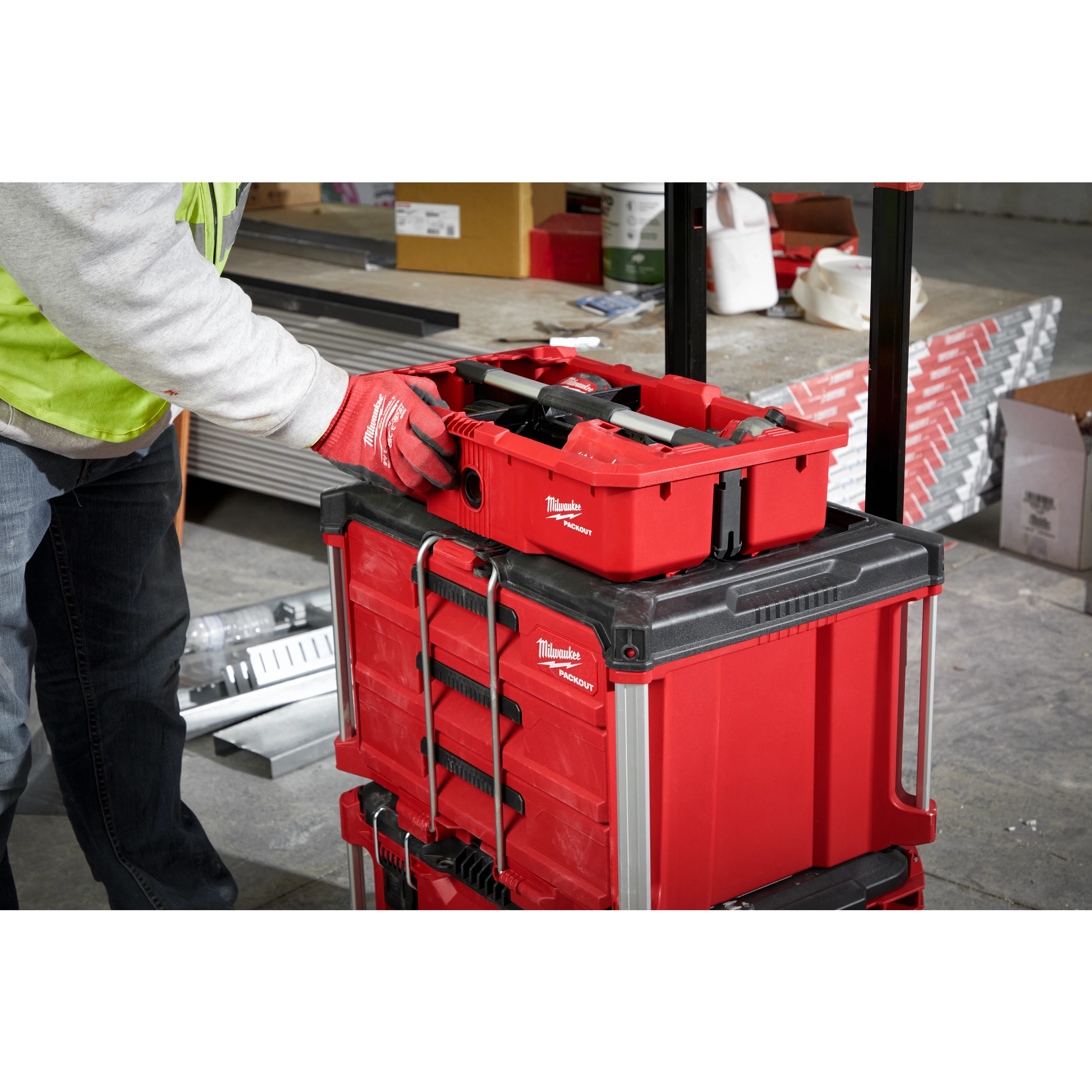 Man putting the PACKOUT Tool Tray inside of the PACKOUT Crate