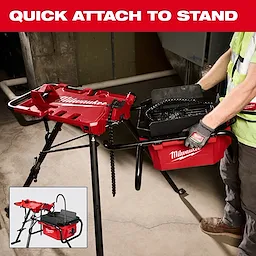 Worker attaching M18 Brushless Pipe Threading Oiler to a red stand in an indoor work area.