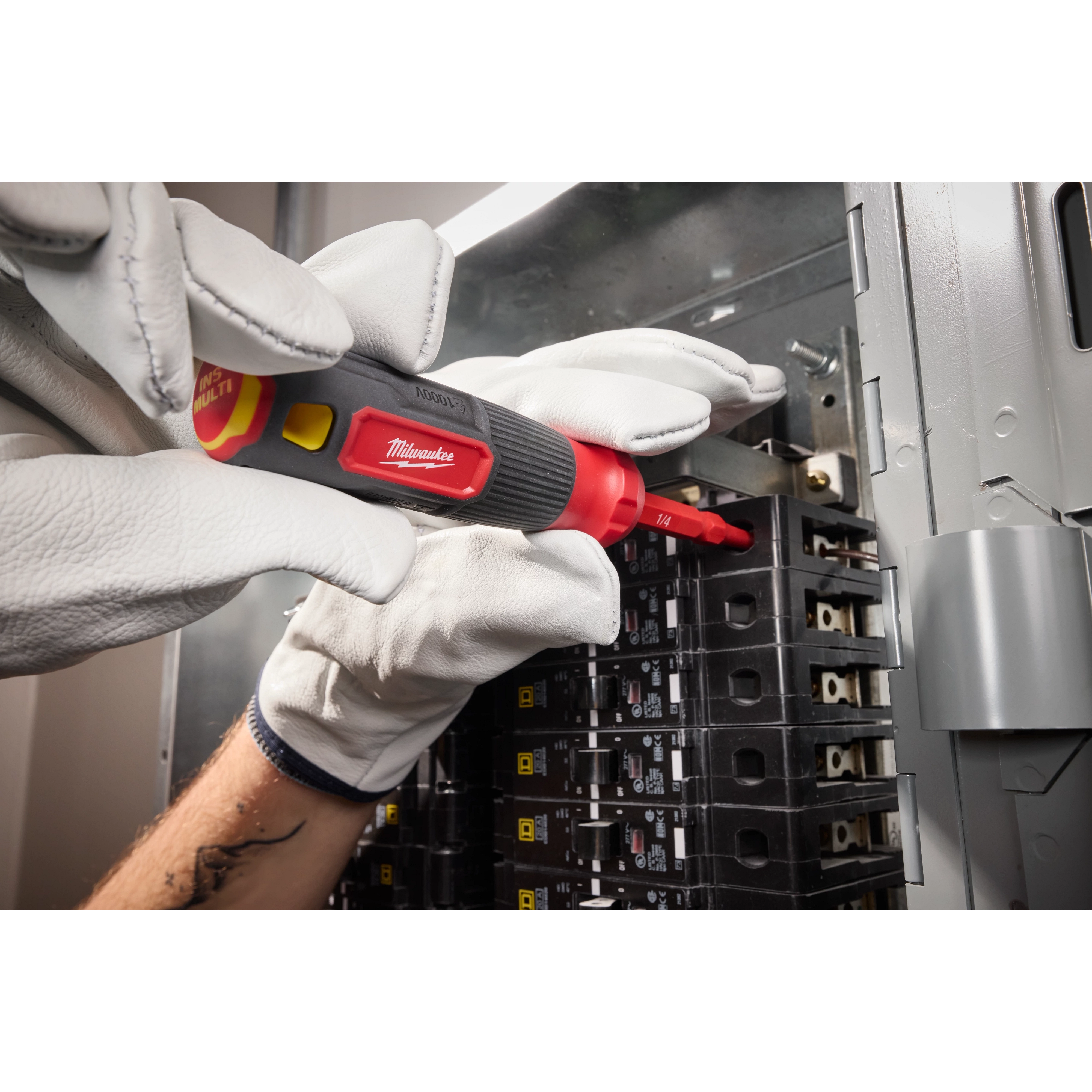 Person using the 2-in-1 1000V Insulated Flip Shank Multi-Bit Screwdriver to work on an electrical panel while wearing white gloves.