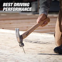 23oz Milled Face Hickory Handle Framing Hammer driving a nail into plywood on a construction surface.