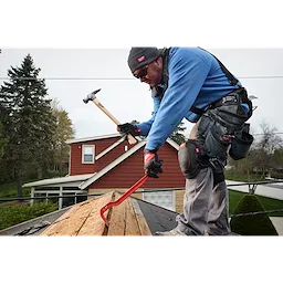 Worker using a 23oz Milled Face Hickory Handle Framing Hammer while repairing a house roof.