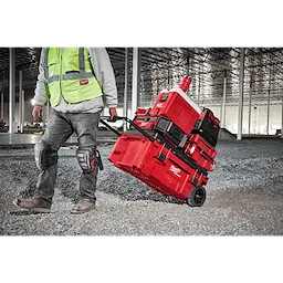 Worker easily pulling the PACKOUT Modular Storage System on the jobsite