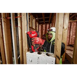 Worker using the M12 Cable Stapler with the attached LED Work light on the jobsite