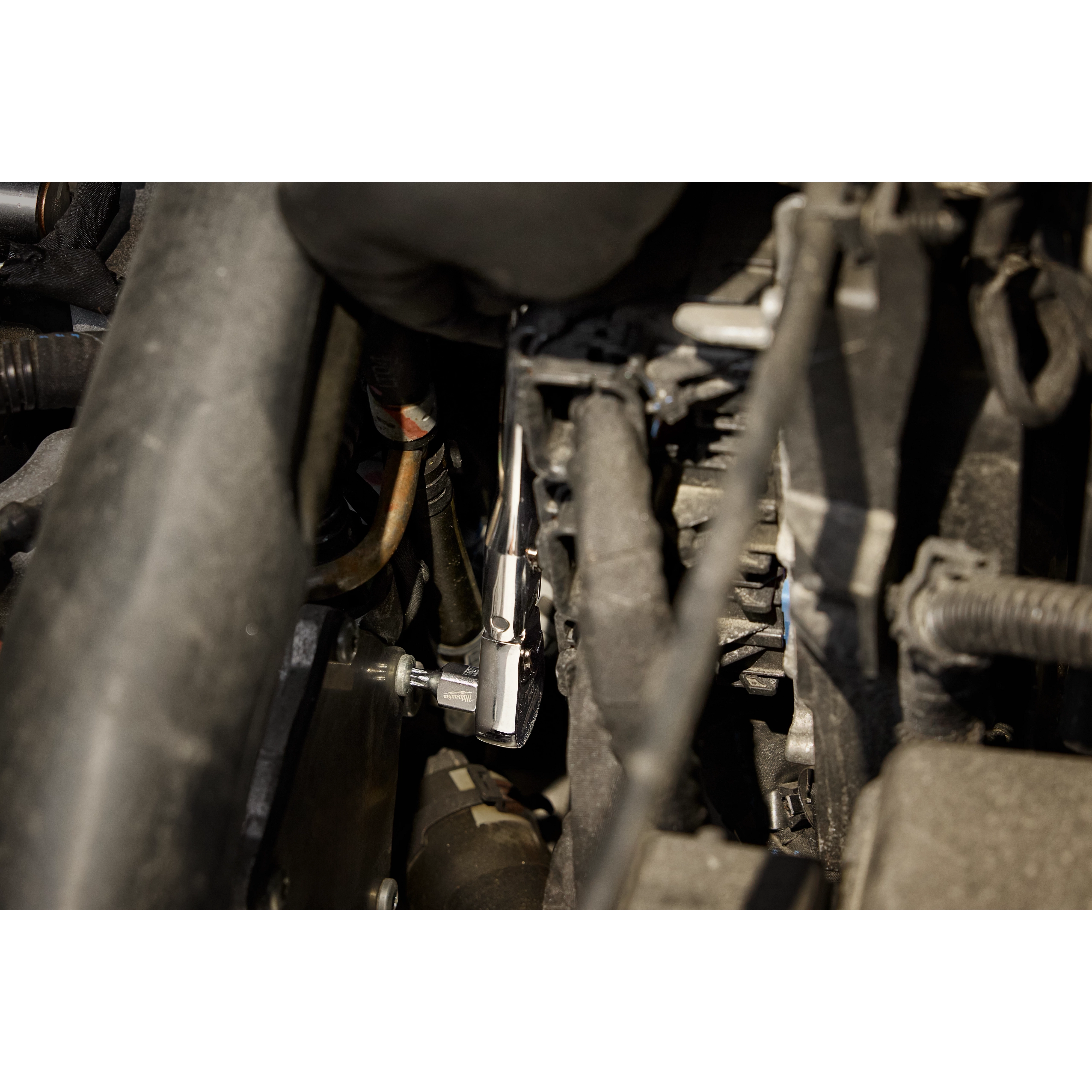 The 1/4" Drive T27 Low-Profile TORX Bit Socket is being used in a mechanical setting, possibly within a vehicle engine compartment.