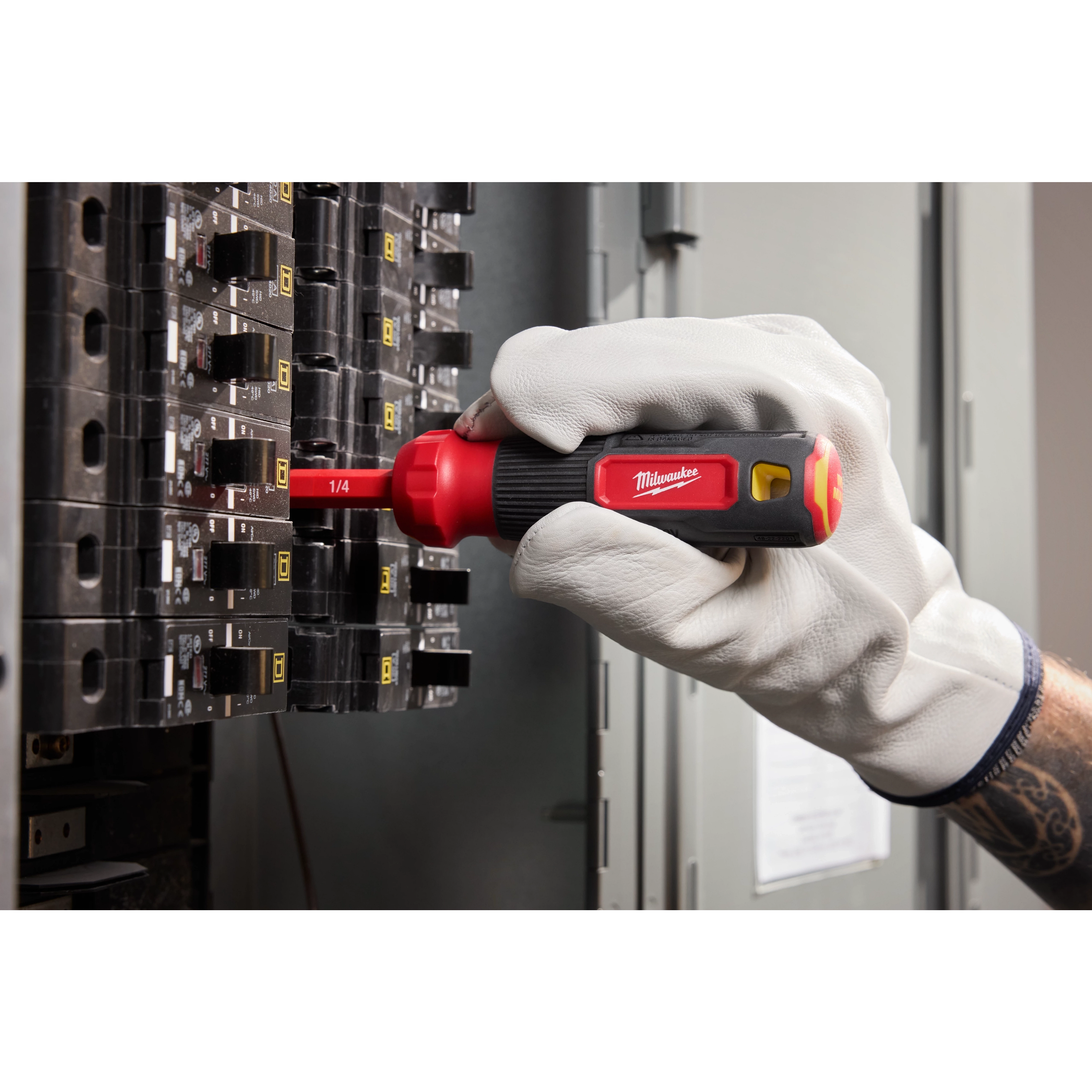 A 2-in-1 1000V Insulated Flip Shank Multi-Bit Screwdriver is being used on an electrical panel.