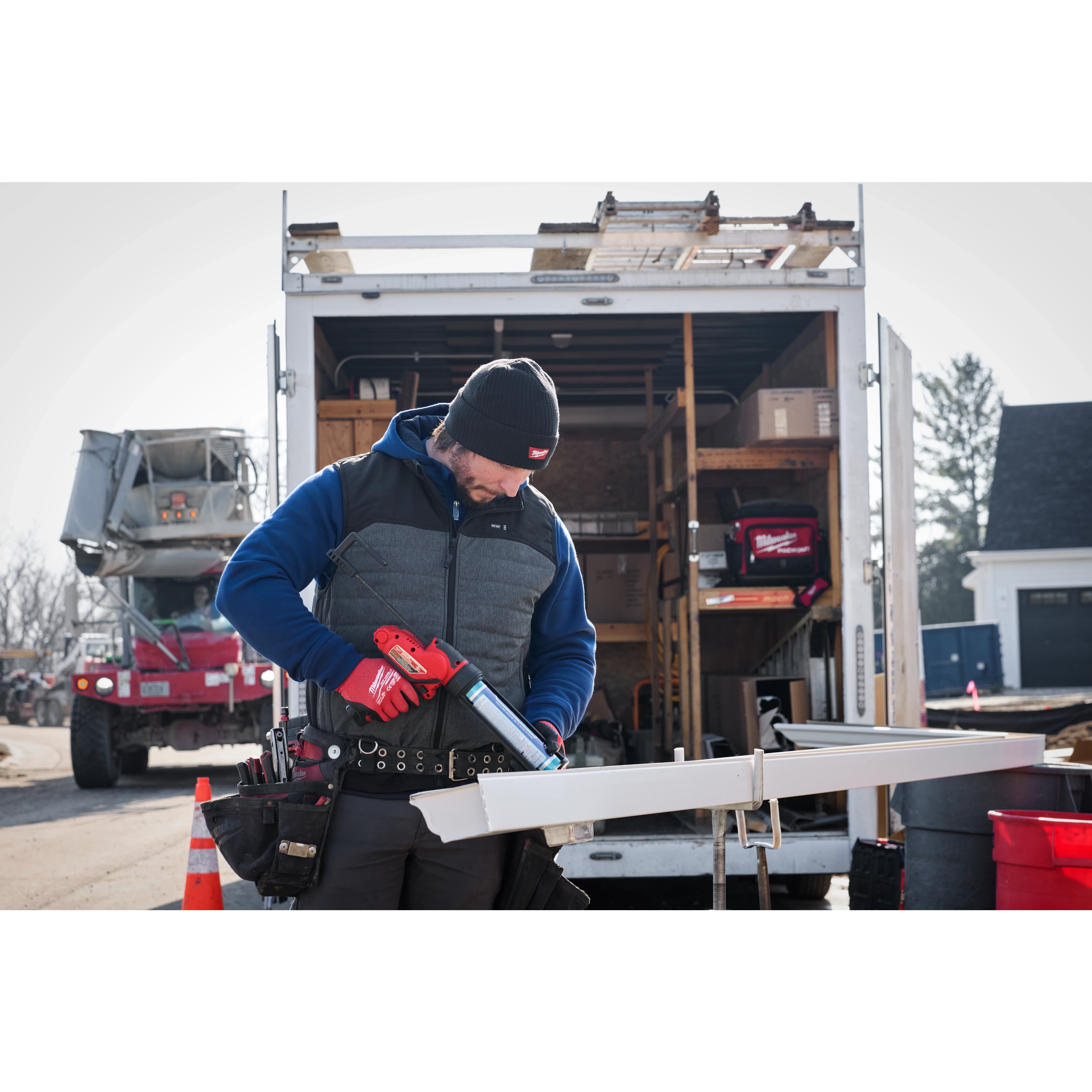 Image of a man on a jobsite wearing the Milwaukee Rib-Knit Cuffed Beanie in black