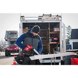 Image of a man on a jobsite wearing the Milwaukee Rib-Knit Cuffed Beanie in black