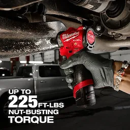 A person uses the M12 FUEL™ 3/8" Subcompact Impact Wrench w/ Friction Ring to remove a bolt from a vehicle part. The text on the image indicates it has up to 225 ft-lbs of nut-busting torque.