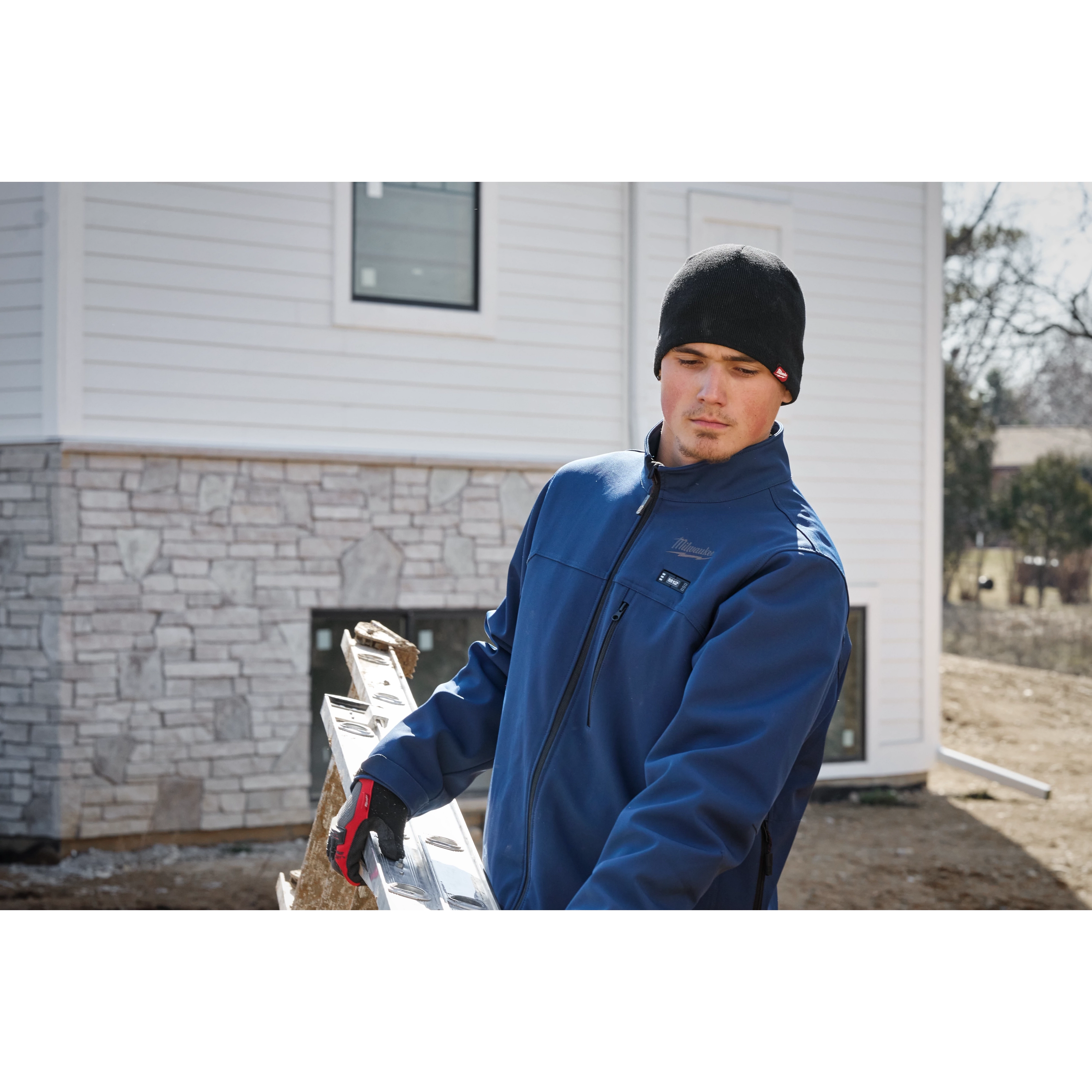 Image of a man on a jobsite wearing the Milwaukee Fleece-Lined Beanie in black
