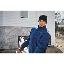 Image of a man on a jobsite wearing the Milwaukee Fleece-Lined Beanie in black