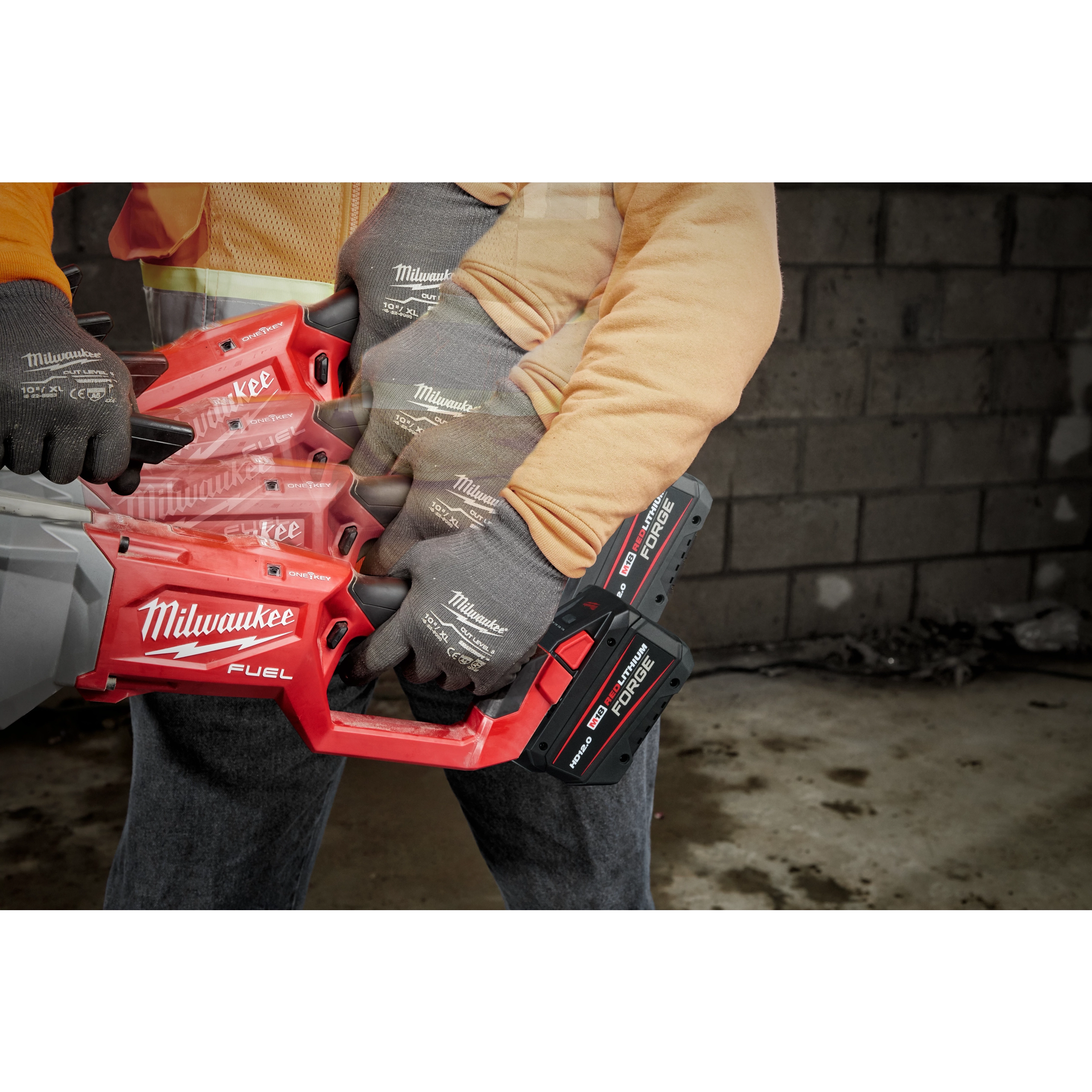 A person using the M18 FUEL™ Pipe Threader w/ ONEKEY. The image shows multiple positions of the handle to demonstrate its versatility. The tool is red and black with "Milwaukee FUEL" branding visible. The user is wearing gloves with the "Milwaukee" logo on them.