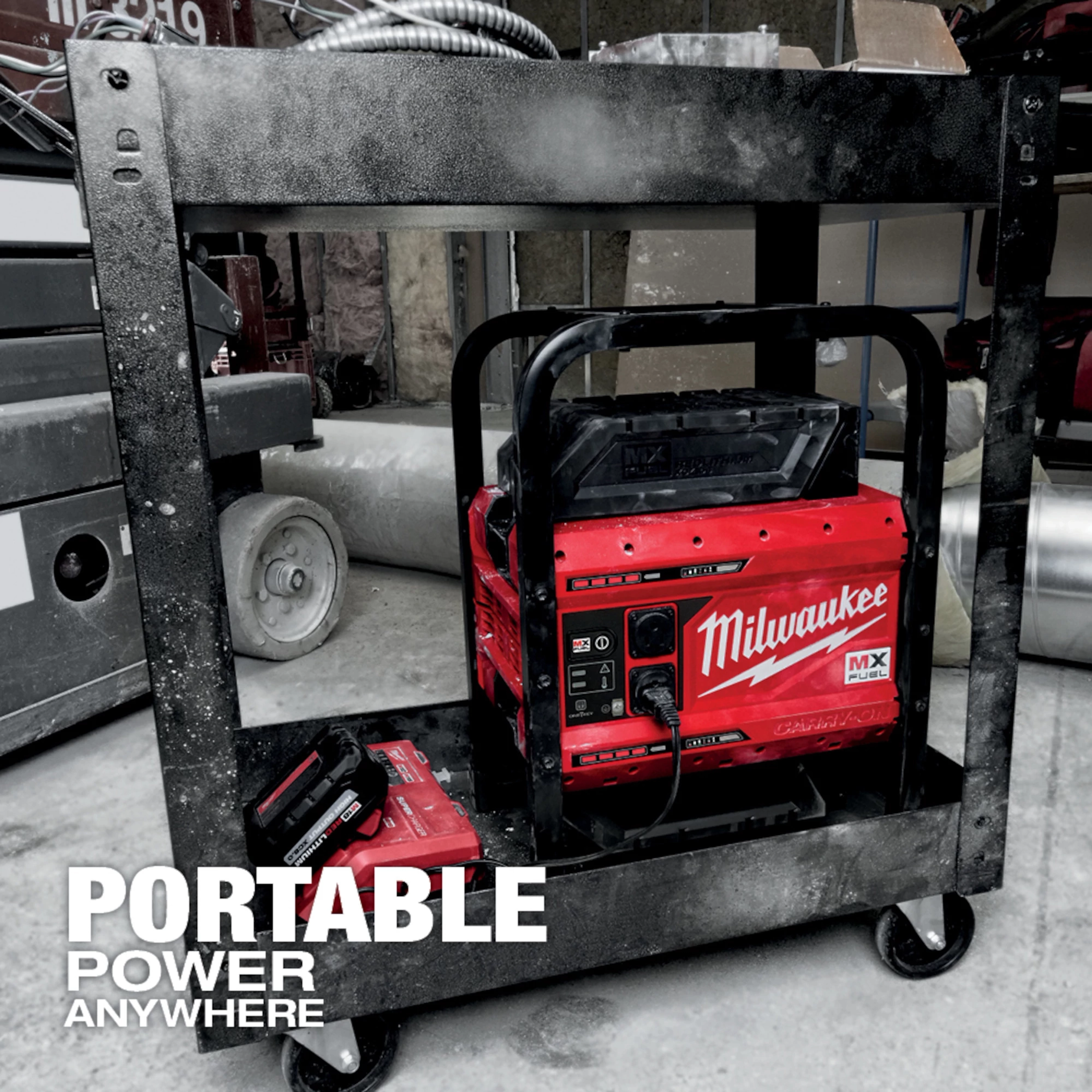 Red MX FUEL CARRY-ON 3600W/1800W Power Supply unit on a metal cart in a construction area with tools and equipment around.