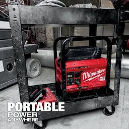 Red MX FUEL CARRY-ON 3600W/1800W Power Supply unit on a metal cart in a construction area with tools and equipment around.