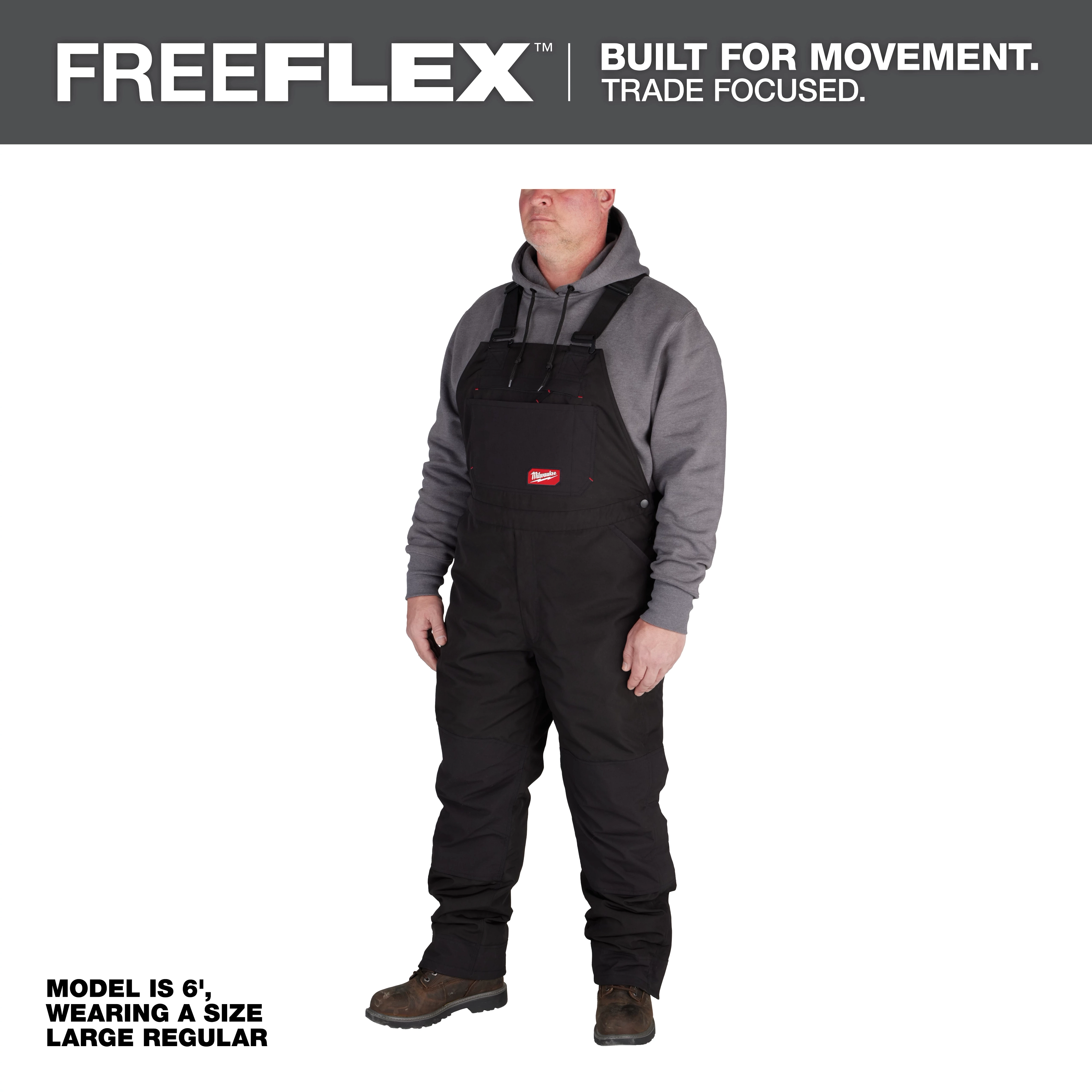 Man wearing FREEFLEX Insulated Bib Overalls with a grey hoodie underneath. Caption reads: "Model is 6', wearing a size Large Regular."