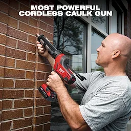 A person is using a red and black Milwaukee cordless caulk gun on a brick wall, standing in front of a window. The text "MOST POWERFUL CORDLESS CAULK GUN" is displayed at the top.