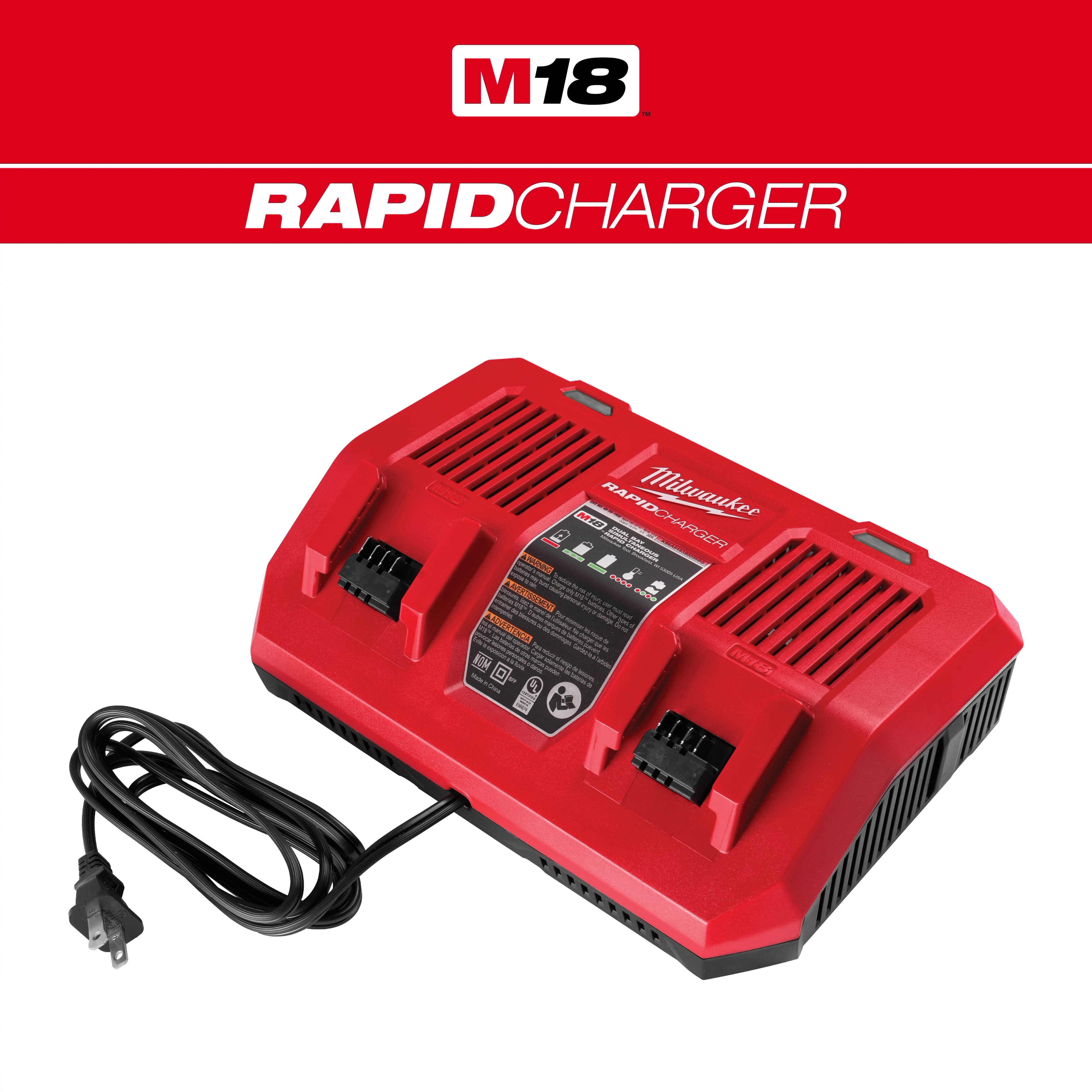 Red M18 Dual Bay Simultaneous Rapid Charger with two battery slots and a black power cord resting on the side.