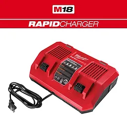Red M18 Dual Bay Simultaneous Rapid Charger with two battery slots and a black power cord resting on the side.