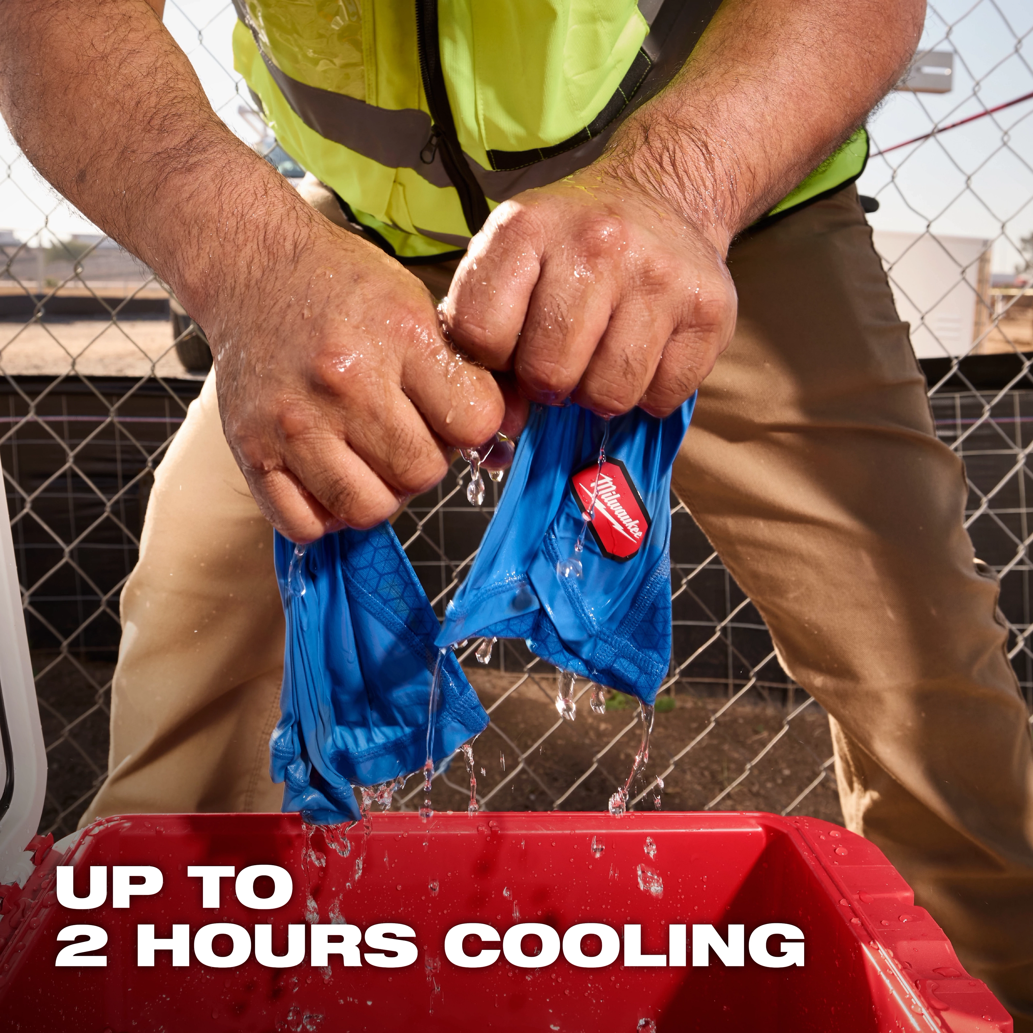 Person wringing out a blue Cooling Neck Gaiter over a red container, with water dripping and text reading "UP TO 2 HOURS COOLING".