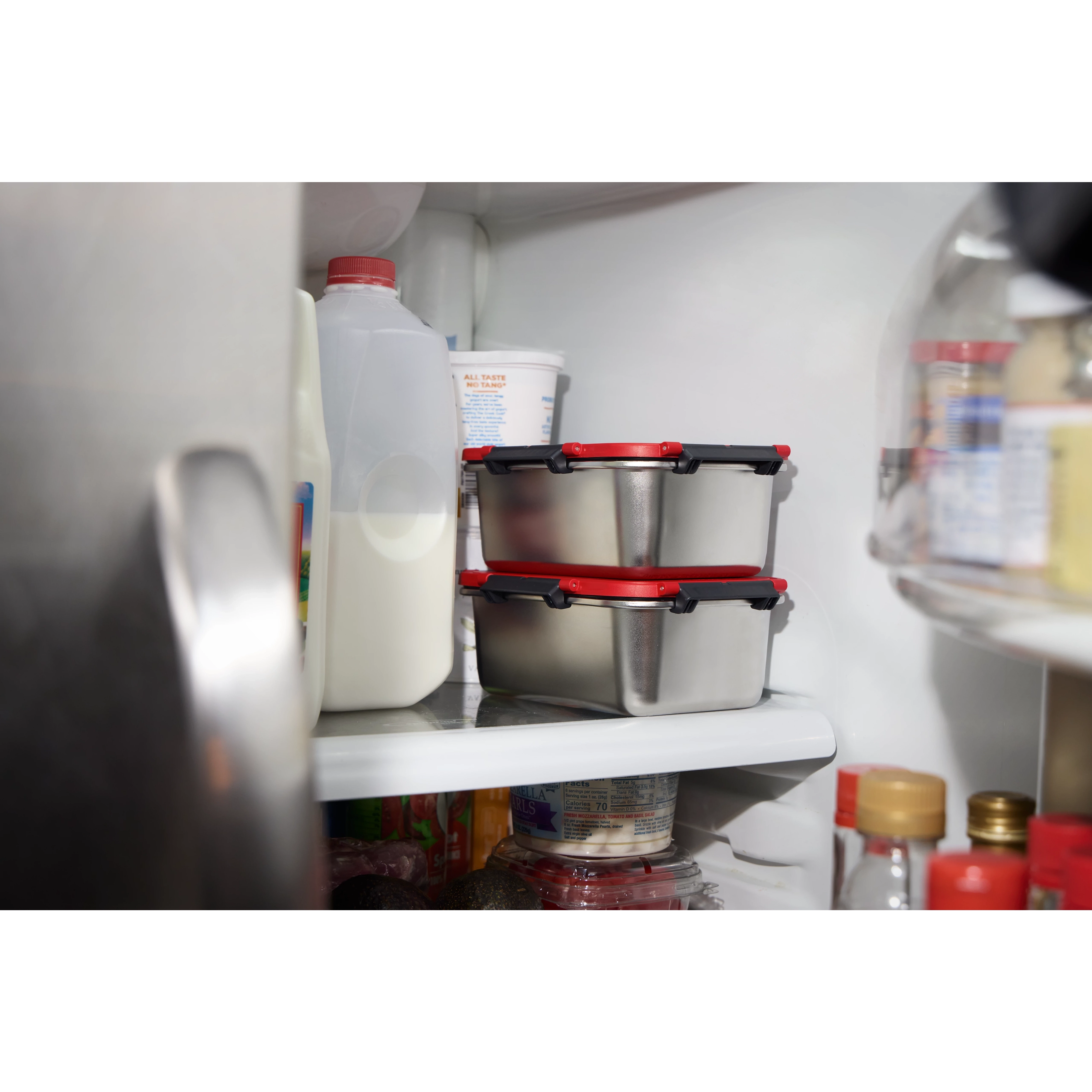 Stainless Steel Containers for M18 Jobsite Lunch Warmer stacked on a refrigerator shelf.