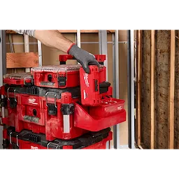 Attaching a red PACKOUT Tool Box Tray Attachment to a stack of PACKOUT toolboxes