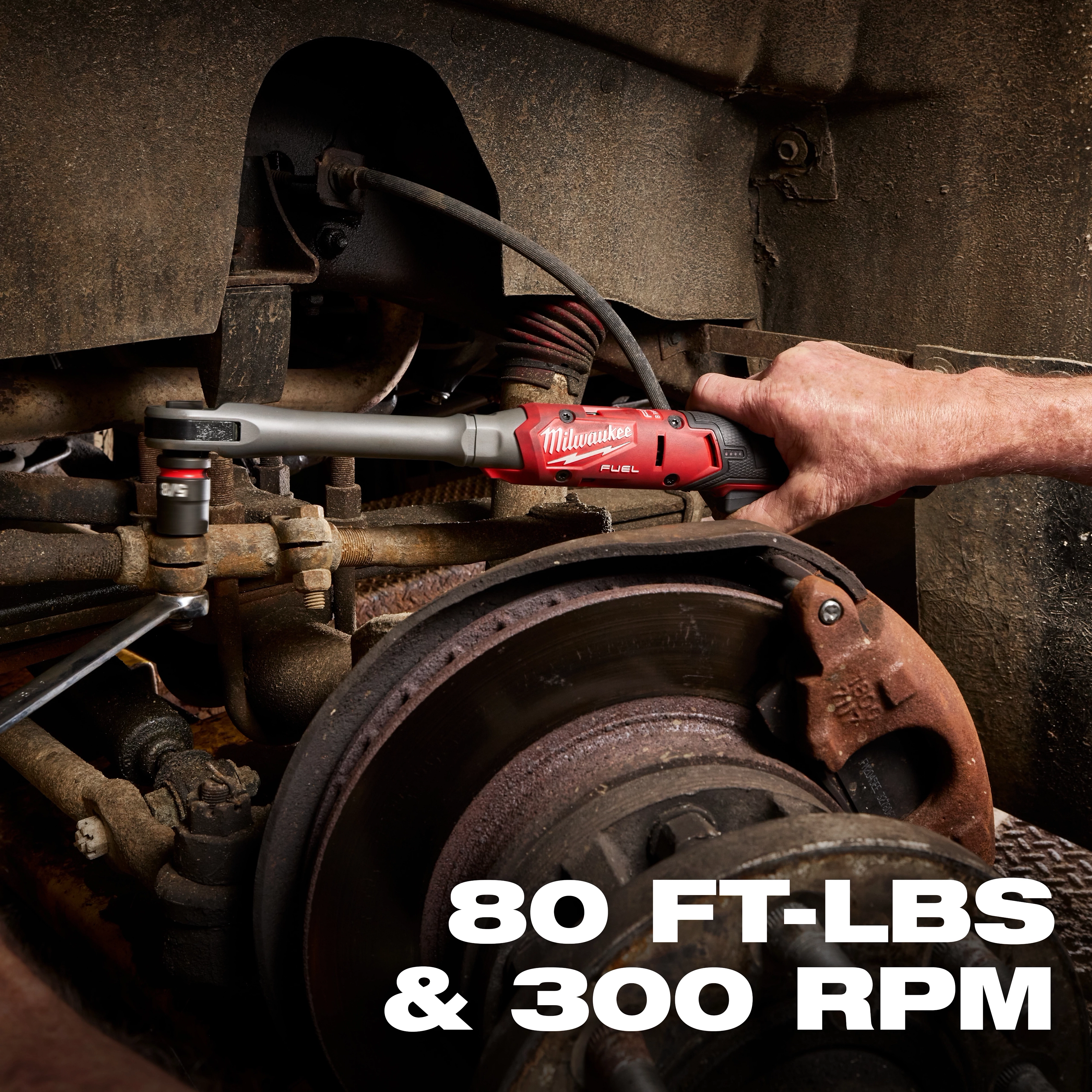 M12 FUEL 1/2" Extended Reach Ratchet tightening a bolt in a vehicle wheel assembly, text reads 80 FT-LBS & 300 RPM.