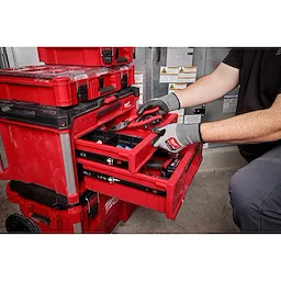 Worker utilizing the PACKOUT 3-Drawer Tool Box to store hand tools