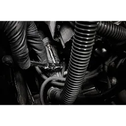 1/4” Hex Drive Mini Flex Head Bit Ratchet tightening a fastener among engine hoses and cables.