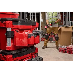 Red PACKOUT Tool Box with a M12 Battery Rack Attachment mounted on its side