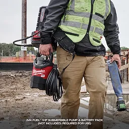 A construction worker holds the MX FUEL™ Portable Pump Power Base in a muddy construction site. The power base is red and black with the Milwaukee logo, and the worker wears a high-visibility vest and carries tools. The text at the bottom reads "(MX FUEL™ 1HP SUBMERSIBLE PUMP & BATTERY PACK (NOT INCLUDED) REQUIRED FOR USE)."