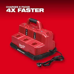 The Milwaukee Rapid Charge Station is a red, heavy-duty battery charger capable of charging six battery packs simultaneously. It features a convenient carrying handle and a power cord, boasting the ability to charge batteries four times faster. The Milwaukee logo is visible on the device.