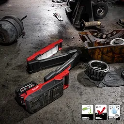 Image of the Milwaukee M18 Magnetic Extendable Boom Light on a jobsite floor highlighting its chemical, water, and impact-resistant features