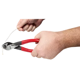 A person is using 8" Angled Head Diagonal Dipped Grip Cutting Pliers (USA) with red handles to cut a piece of white wire. The pliers are angled and have "USA" written on the metal part.