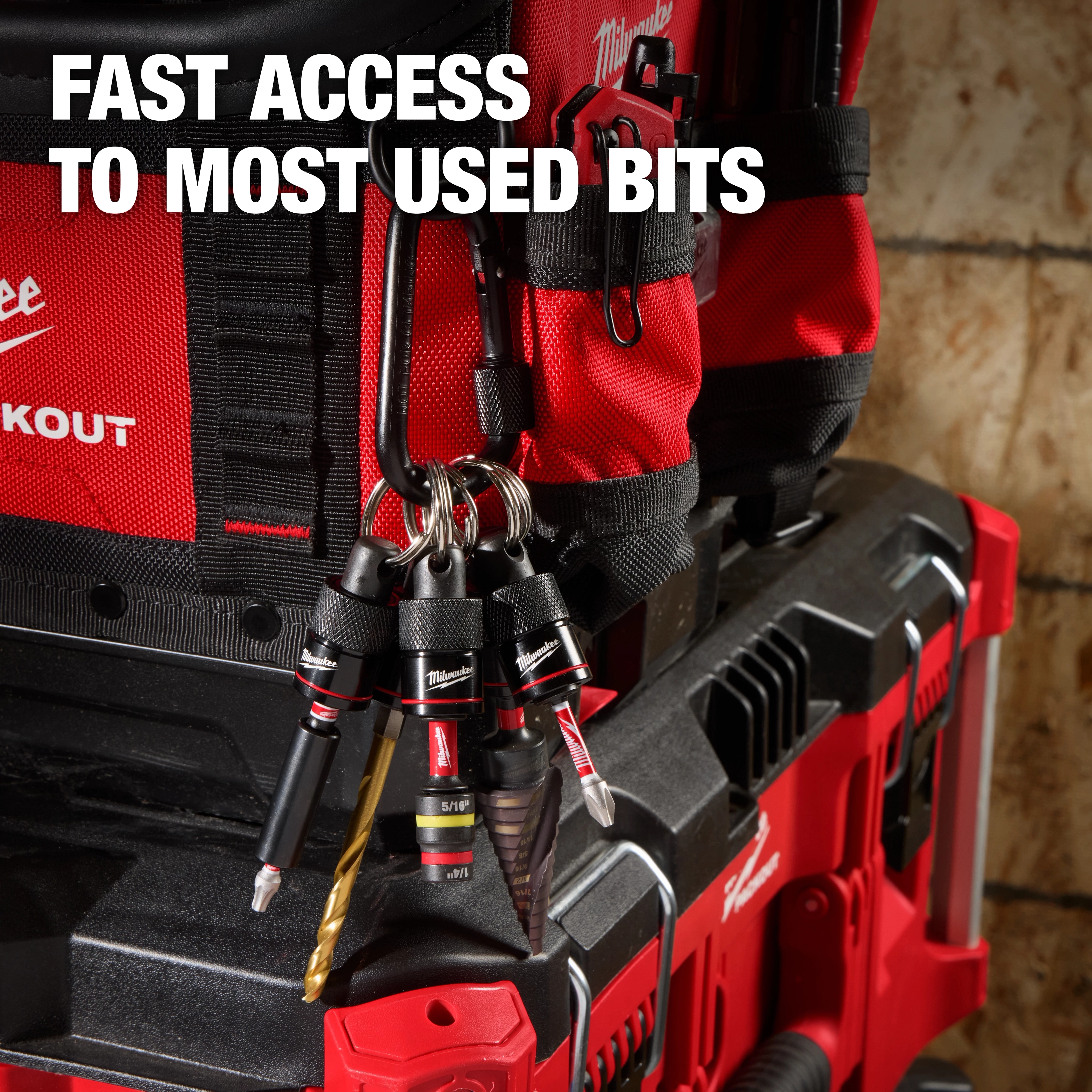 The 5PC Bit Holder with Carabiner from Milwaukee is attached to a red tool bag. The holder securely carries five drill bits, providing quick access. The text on the image reads, "Fast access to most used bits."