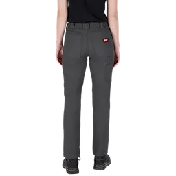 A person wearing gray Women's Work Pants with multiple pockets and a red logo on the back pocket. The person is seen from the back, showing the pants' fit. The image is titled "Women's Work Pants - Gray."