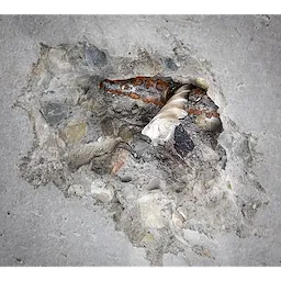SDS-PLUS 4CT MX4 1/2" X 4" X 6" drill bit embedded in broken concrete, highlighting its drilling and chipping performance.