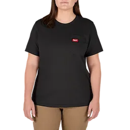 A person wearing the Women's GRIDIRON™ Pocket T-Shirt - Short Sleeve Black. The black t-shirt features a small pocket on the upper left side with a red tag. The person is also wearing beige pants.