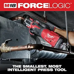 M18 FORCE LOGIC Press Tool w/ONE-KEY app is being used to press a fitting onto a copper pipe in an industrial setting.