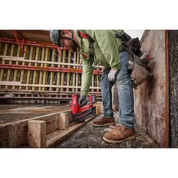 Image of  worker using the Milwaukee M18 Duplex Nailer to nail wood on a jobsite