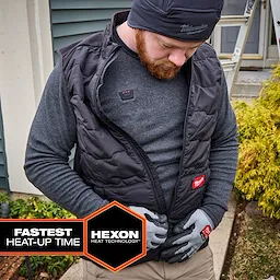 Person wearing a Milwaukee Heated Merino Wool Crew Neck Baselayer under a zippered vest outdoors