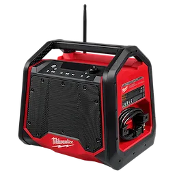 The Milwaukee M18™ Bluetooth® Jobsite Radio + Charger features a sturdy red and black design with a large speaker grille, control buttons on top, and a side compartment for cable storage. The device offers Bluetooth connectivity and charging capabilities for other devices, making it ideal for job sites.