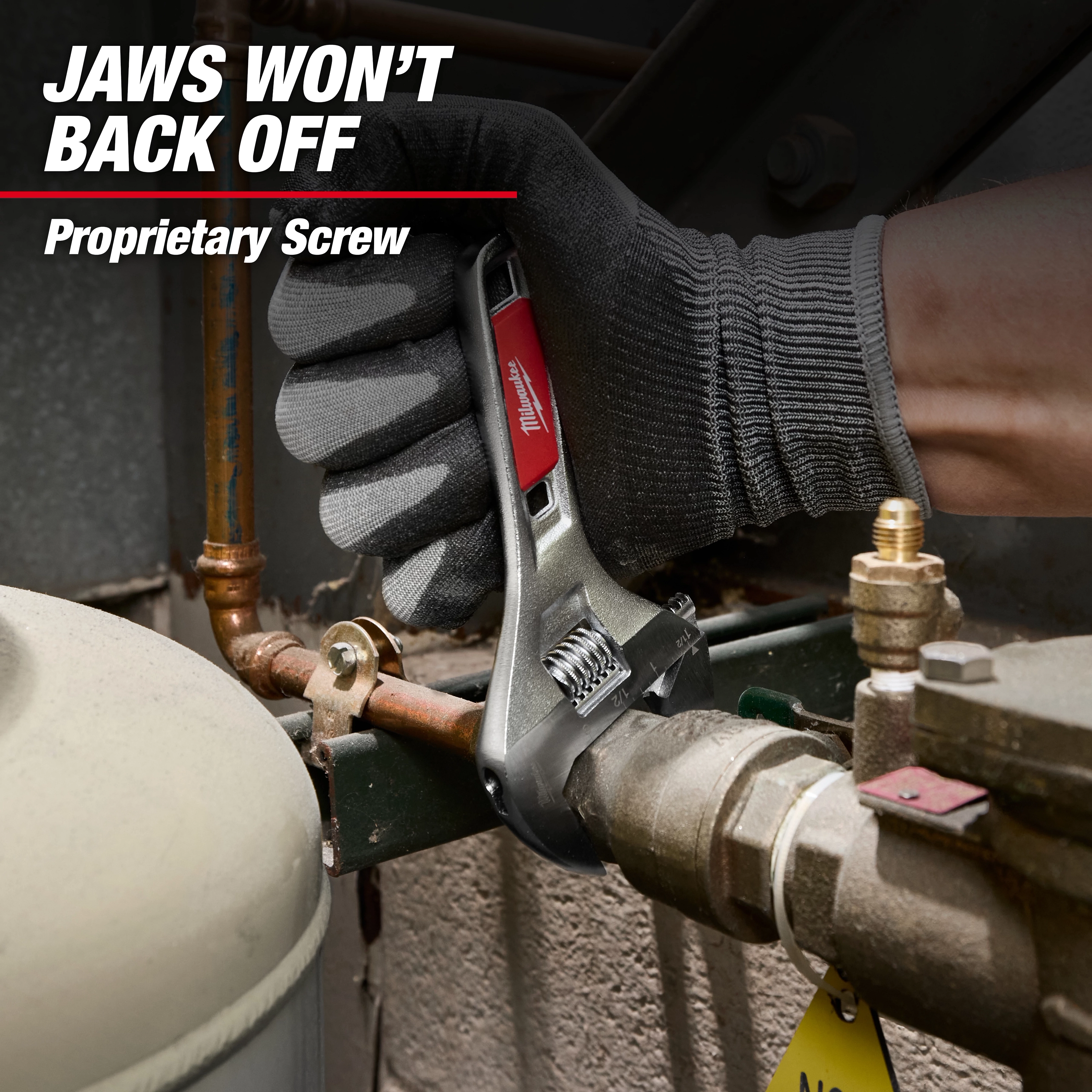 Gloved hand using 6" Adjustable Wrench on piping.