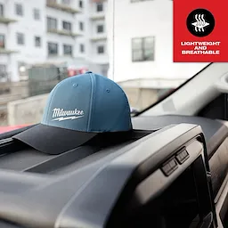 WORKSKIN Performance Fitted Hat in blue displayed on a vehicle dashboard, with a "Lightweight and Breathable" label in the corner.