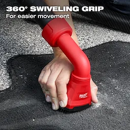 A person is using the AIR-TIP™ Swiveling Palm Brush on a carpet. The tool has a red handle with a 360° swiveling grip, designed for easier movement. Text on the image reads, "360° SWIVELING GRIP For easier movement."